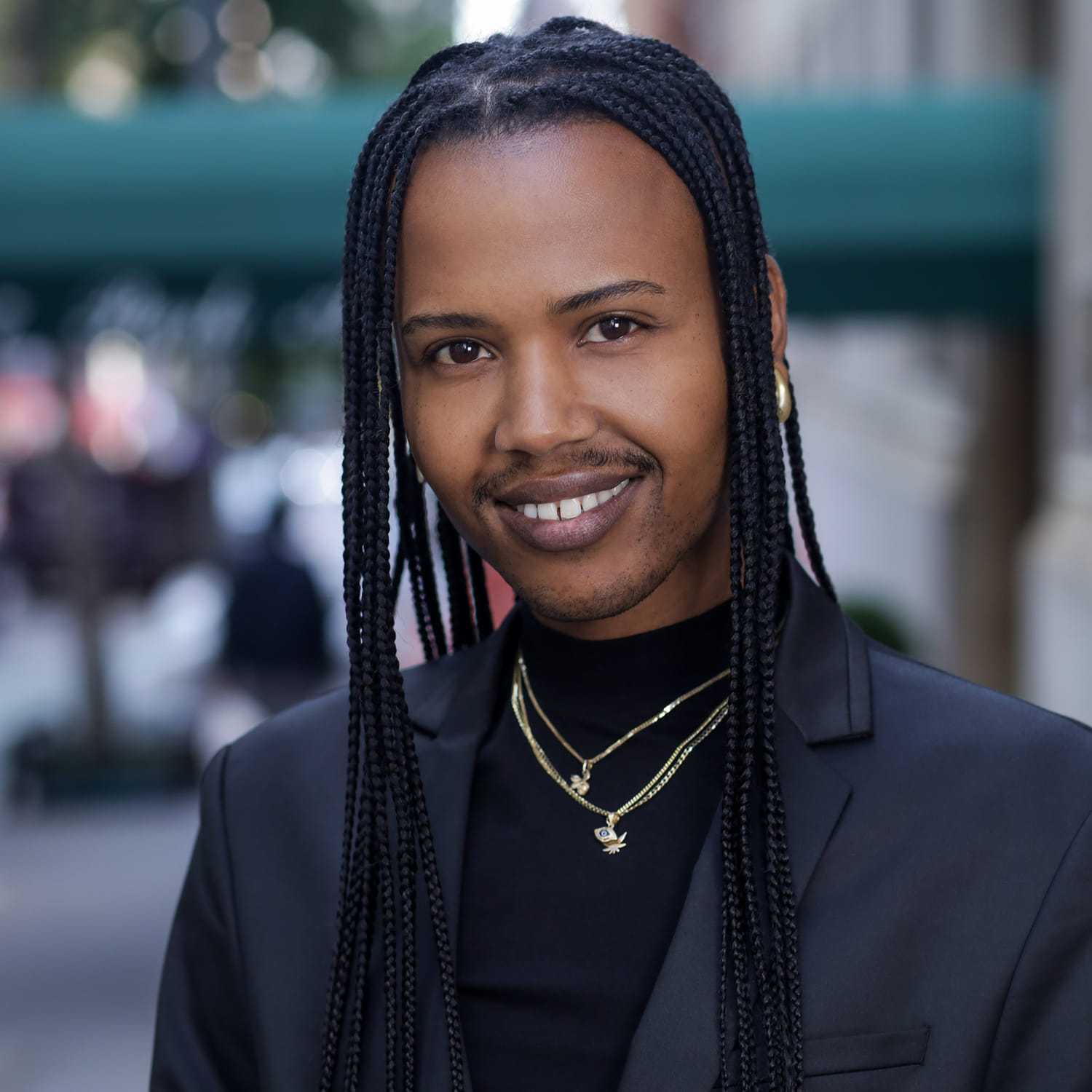 Portrait of RASHIK, a professional stylist at Fringe Salon NY, showcasing their expertise and style.