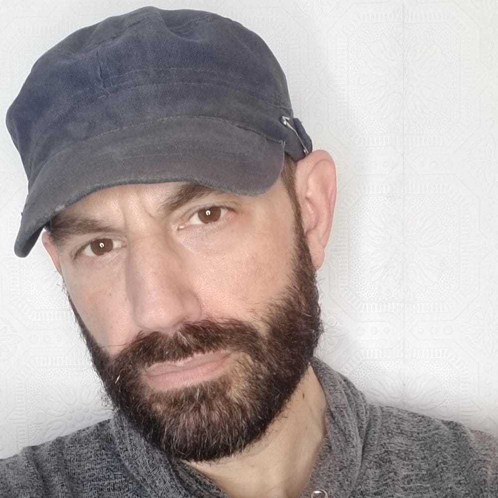 Portrait of JOE C, a professional stylist at Fringe Salon NY, showcasing their expertise and style.