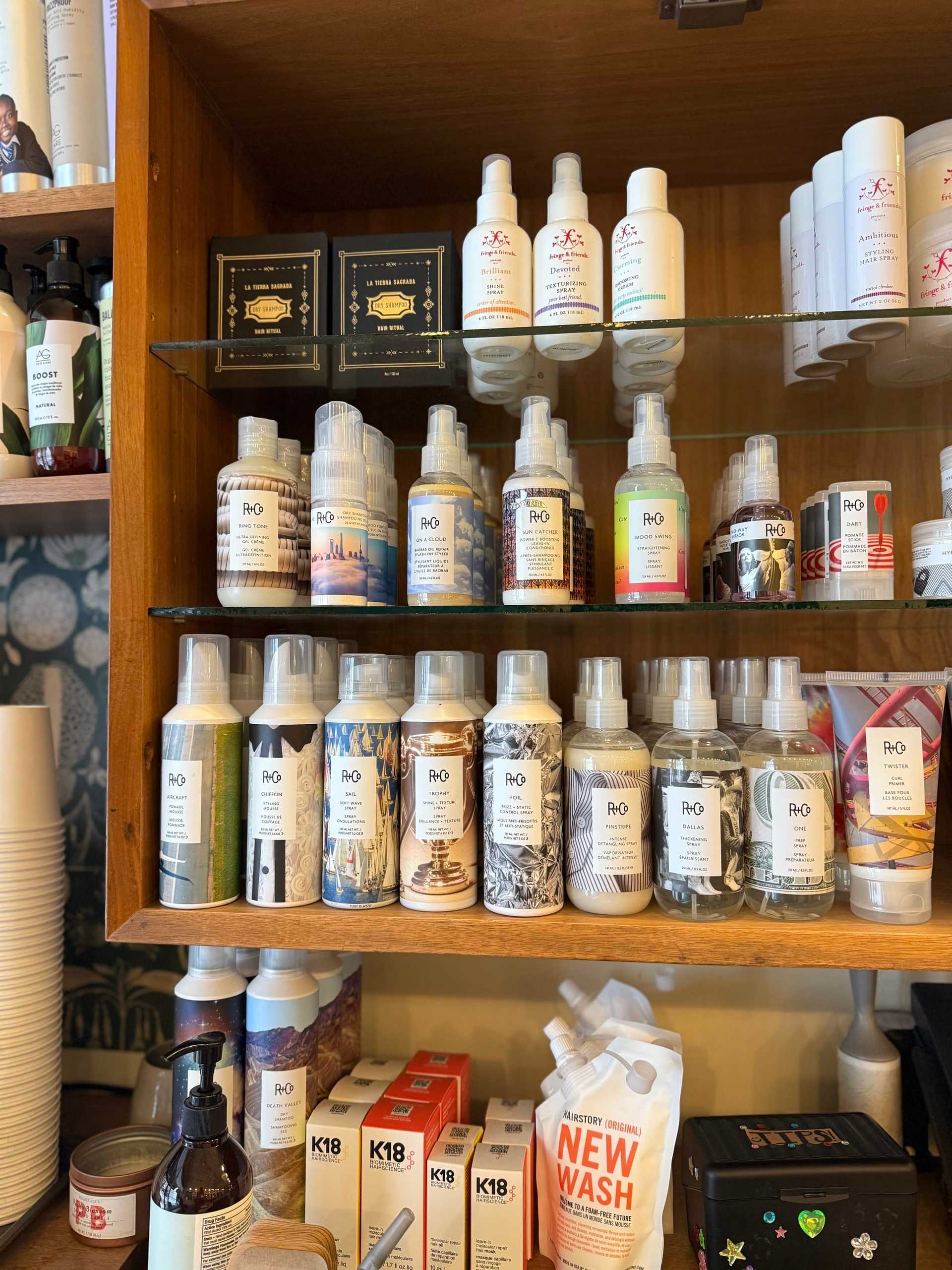 Hair and body care products displayed on wooden shelves in a store.